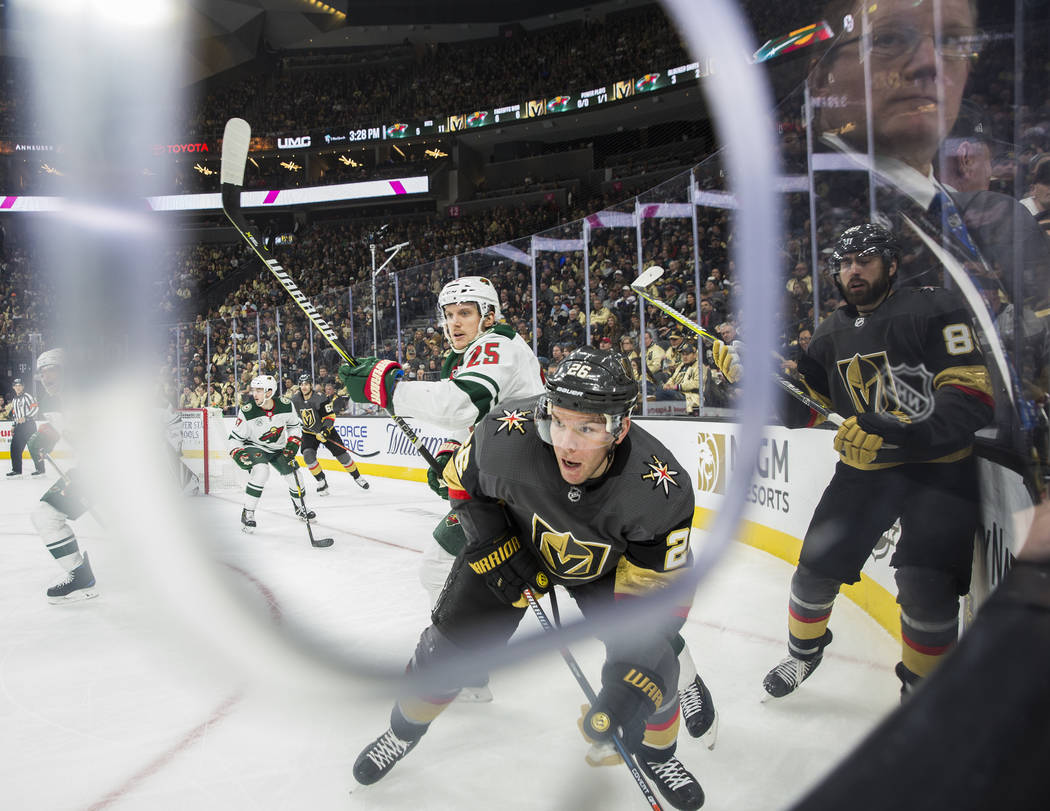 Golden Knights center Paul Stastny (26) fights for a loose puck with Minnesota Wild defenseman Jonas Brodin (25) in the first period on Monday, Jan. 21, 2019, at T-Mobile Arena, in Las Vegas. (Be ...
