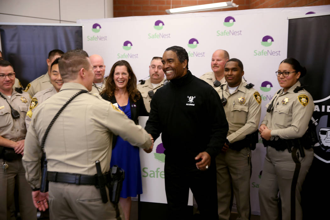 Raiders alumnus Leo Gray shakes hands with Las Vegas police Lt. Timothy Hatchett at SafeNest headquarters in Las Vegas on Thursday, Jan. 24, 2019. Hatchett initiated Project Safe 417, a partnershi ...