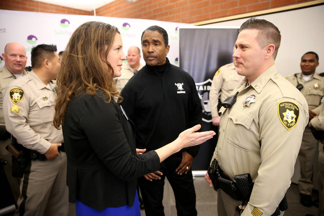 SafeNest CEO Liz Ortenburger visits with Las Vegas police Lt. Timothy Hatchett and Raiders alumnus Leo Gray at SafeNest headquarters in Las Vegas on Thursday, Jan. 24, 2019. Hatchett initiated Pro ...