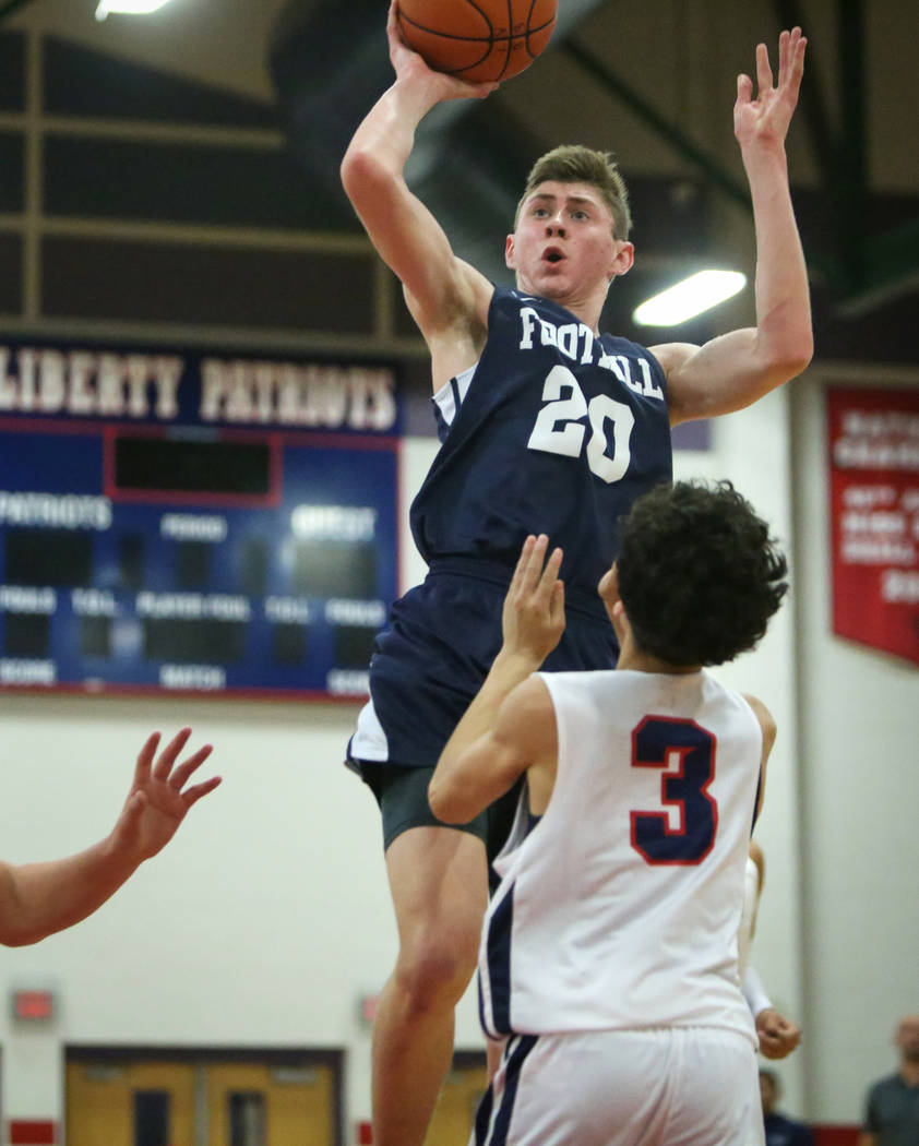 Foothill's Caleb Stearman (20) jumps up to take a shot while under pressure from Liberty's Lorenzo Abellar (3) during a basketball game at Liberty High School in Las Vegas, Wednesday, Jan. 23, 201 ...
