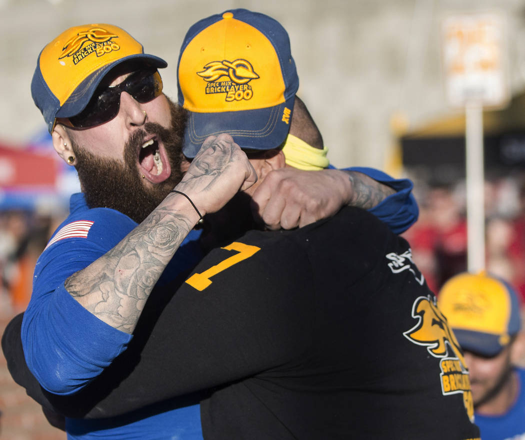 Mario Alves, left, from Hamilton, Ontario celebrates with teammate and brother Michael Alves after winning the Spec Mix Bricklayer 500 during day two of the World of Concrete trade show on Wednesd ...