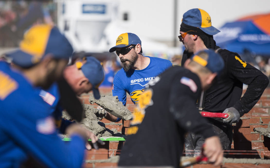 David Wernette, middle, from Marysville, Wash., competes in the Spec Mix Bricklayer 500 during day two of the World of Concrete trade show on Wednesday, Jan. 23, 2019, at the Las Vegas Convention ...