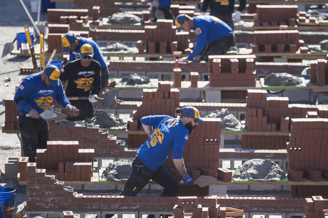 Mario Alves, middle, from Hamilton, Ontario competes in the Spec Mix Bricklayer 500 during day two of the World of Concrete trade show on Wednesday, Jan. 23, 2019, at the Las Vegas Convention Cent ...