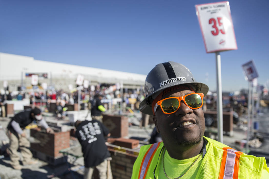 Kenneth McLin, right, with Liuna, takes a break during a masonry competition during day two of the World of Concrete trade show on Wednesday, Jan. 23, 2019, at the Las Vegas Convention Center, in ...