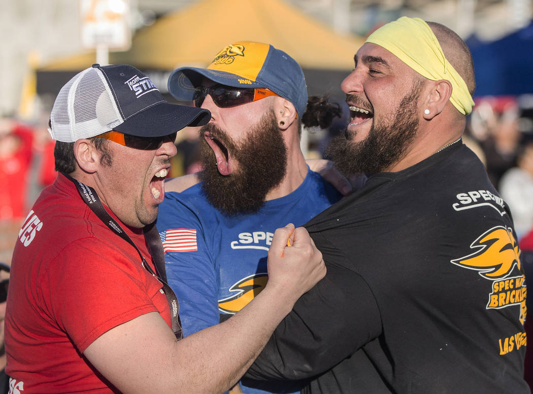 Mario Alves, middle, from Hamilton, Ontario, celebrates with teammate and brother Michael Alves, right, after winning the Spec Mix Bricklayer 500 during day two of the World of Concrete trade show ...