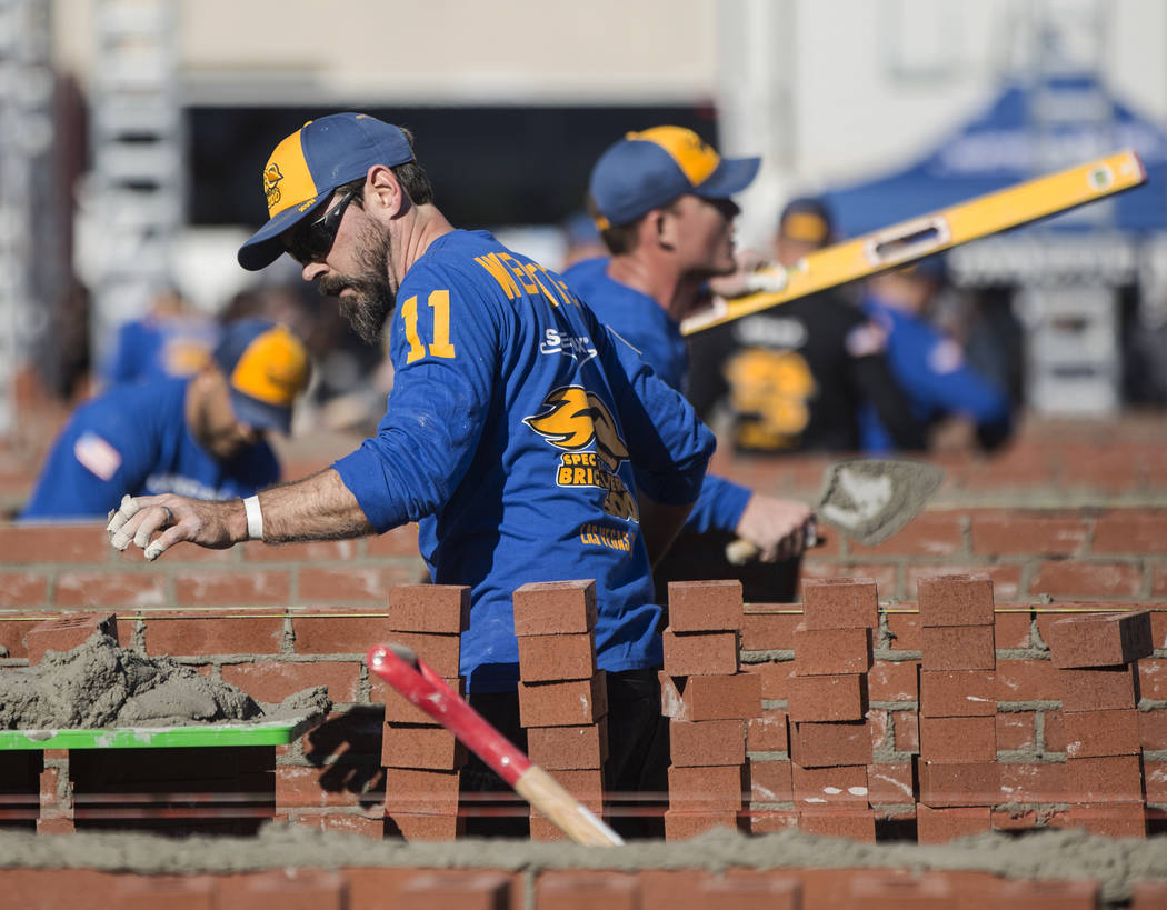 David Wernette, left, from Marysville, Wash., competes in the Spec Mix Bricklayer 500 during day two of the World of Concrete trade show on Wednesday, Jan. 23, 2019, at the Las Vegas Convention Ce ...