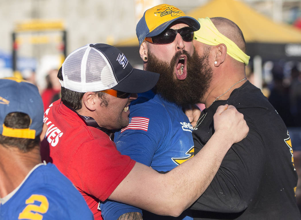 Mario Alves, middle, from Hamilton, Ontario celebrates with his team after winning the Spec Mix Bricklayer 500 during day two of the World of Concrete trade show on Wednesday, Jan. 23, 2019, at th ...