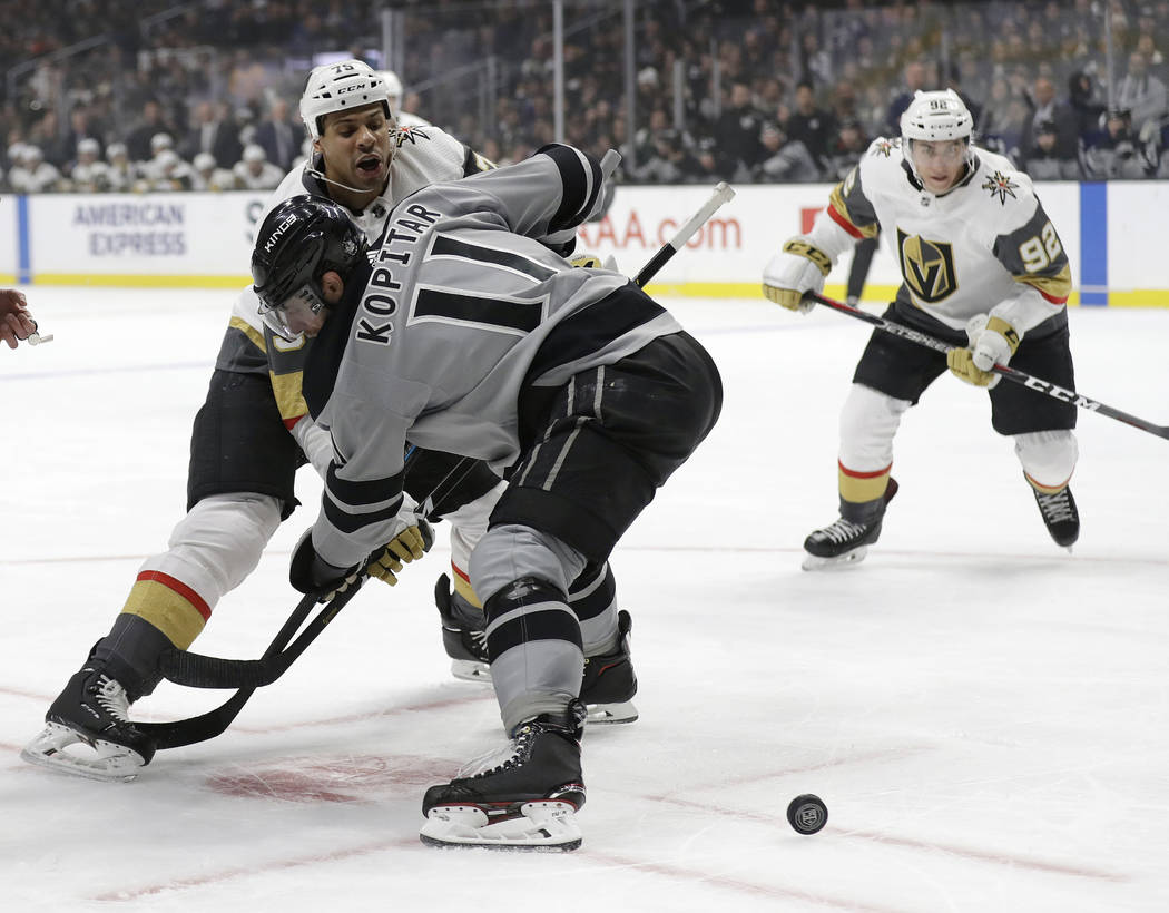 Vegas Golden Knights' Ryan Reaves, left, faces off against Los Angeles Kings' Anze Kopitar during the first period of an NHL hockey game Saturday, Dec. 29, 2018, in Los Angeles. (AP Photo/Marcio J ...