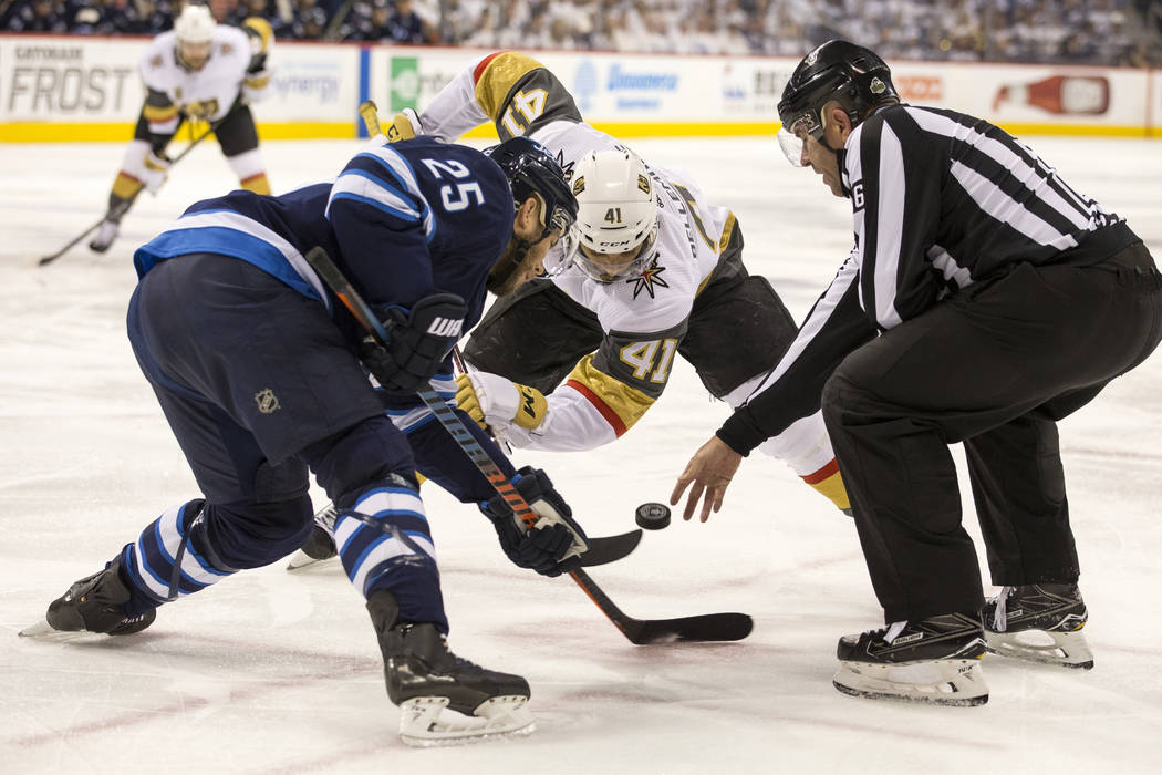 Winnipeg Jets center Paul Stastny (25) and Vegas Golden Knights left wing Pierre-Edouard Bellemare (41) face-off during the second period in Game 2 of an NHL hockey third round playoff series at t ...