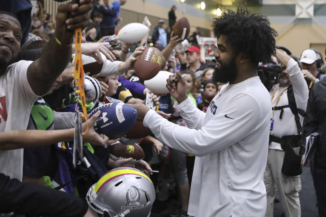 NFC running back Ezekiel Elliott signs autographs for fans after the Pro Bowl Practice, Thursday, January 24, 2019, in Kissimmee, FL. (AP Photo/Gregory Payan)