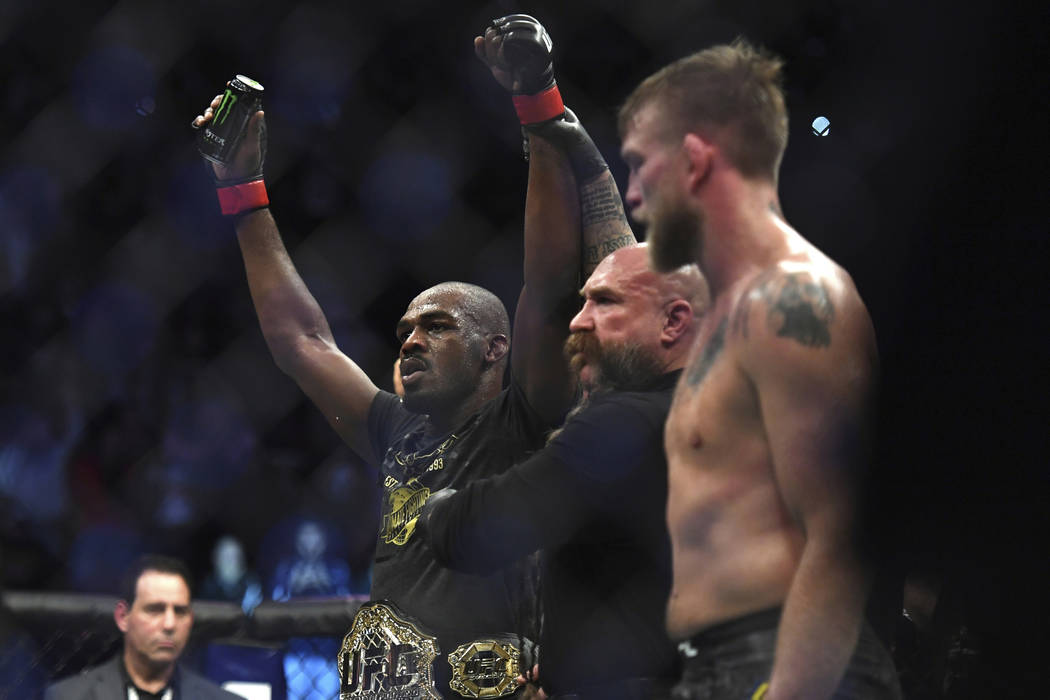 Jon Jones, left, celebrates as the referee raises his arms after Jones defeated Alexander Gustafsson in the UFC men's light heavyweight mixed martial arts bout at UFC 232, Saturday, Dec. 29, 2018, ...