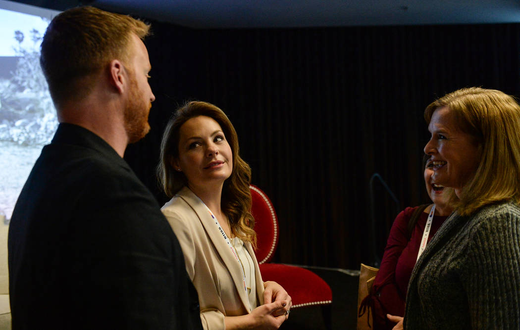 Eric and Lindsey Bennett, stars of HGTV's "Desert Flippers" speak with Cheryl Jones after a panel on flipping houses during the second day of the Las Vegas Market held at the World Market Center i ...
