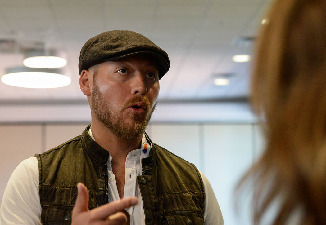 Jordan Betten, a local house flipper in Henderson, speaks with Eric and Lindsey Bennett, stars of HGTV's "Desert Flippers" after a panel on flipping houses during the second day of the Las Vegas M ...