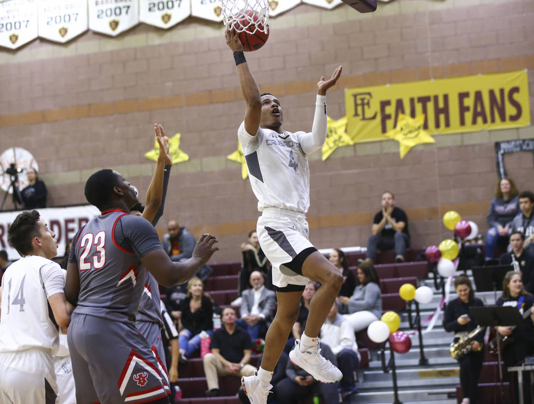 Faith Lutheran's Sedrick Hammond (4) goes to the basket past Arbor View's Jaylon Lee (23) during the second half of a basketball game at Faith Lutheran High School in Las Vegas on Thursday, Jan. 3 ...