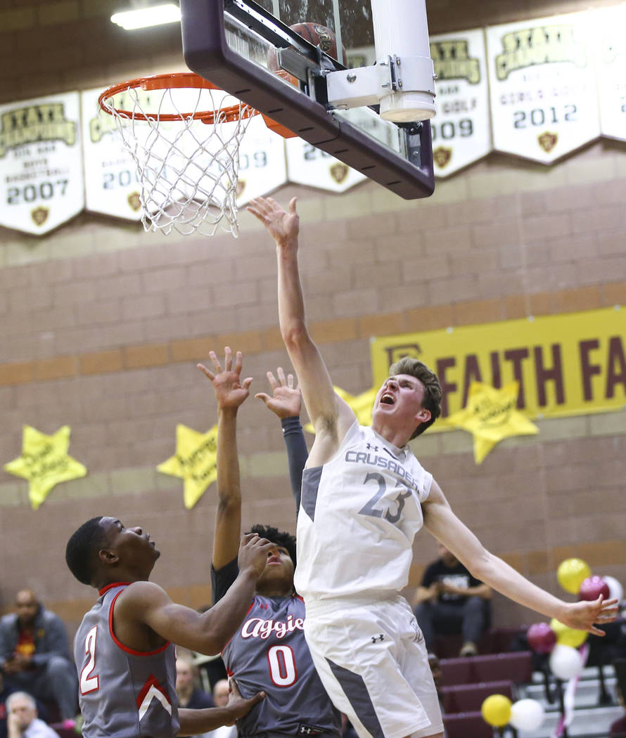 Faith Lutheran's Brevin Walter (23) sends up a shot past Arbor View's Favor Chukwukelu (2) and Donovan Yap (0) during the second half of a basketball game at Faith Lutheran High School in Las Vega ...