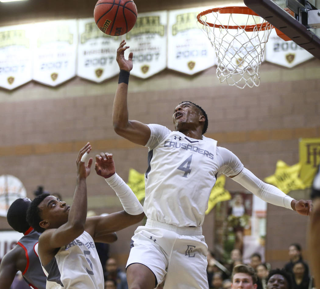 Faith Lutheran's Sedrick Hammond (4) and Azavier Johnson (5) go up for a rebound during the first half of a basketball game at Faith Lutheran High School in Las Vegas on Thursday, Jan. 31, 2019. ( ...