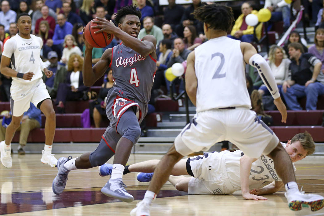 Arbor View's Tyre Williams (4) drives the ball against Faith Lutheran's Donavan Jackson (2) during the first half of a basketball game at Faith Lutheran High School in Las Vegas on Thursday, Jan. ...