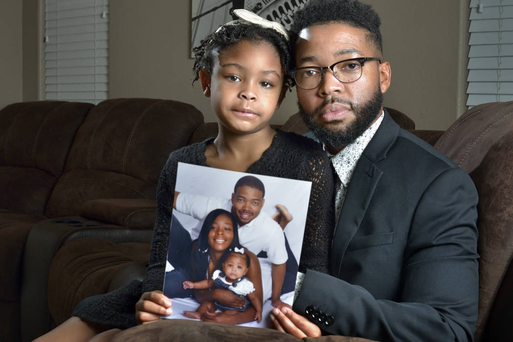 Brooklynn Murray, 7, is shown with her father Dwayne and a family portrait with her mother LaQuinta at their home in Las Vegas on Monday, Jan. 28, 2019. The Murrays won a $42 million settlement ag ...