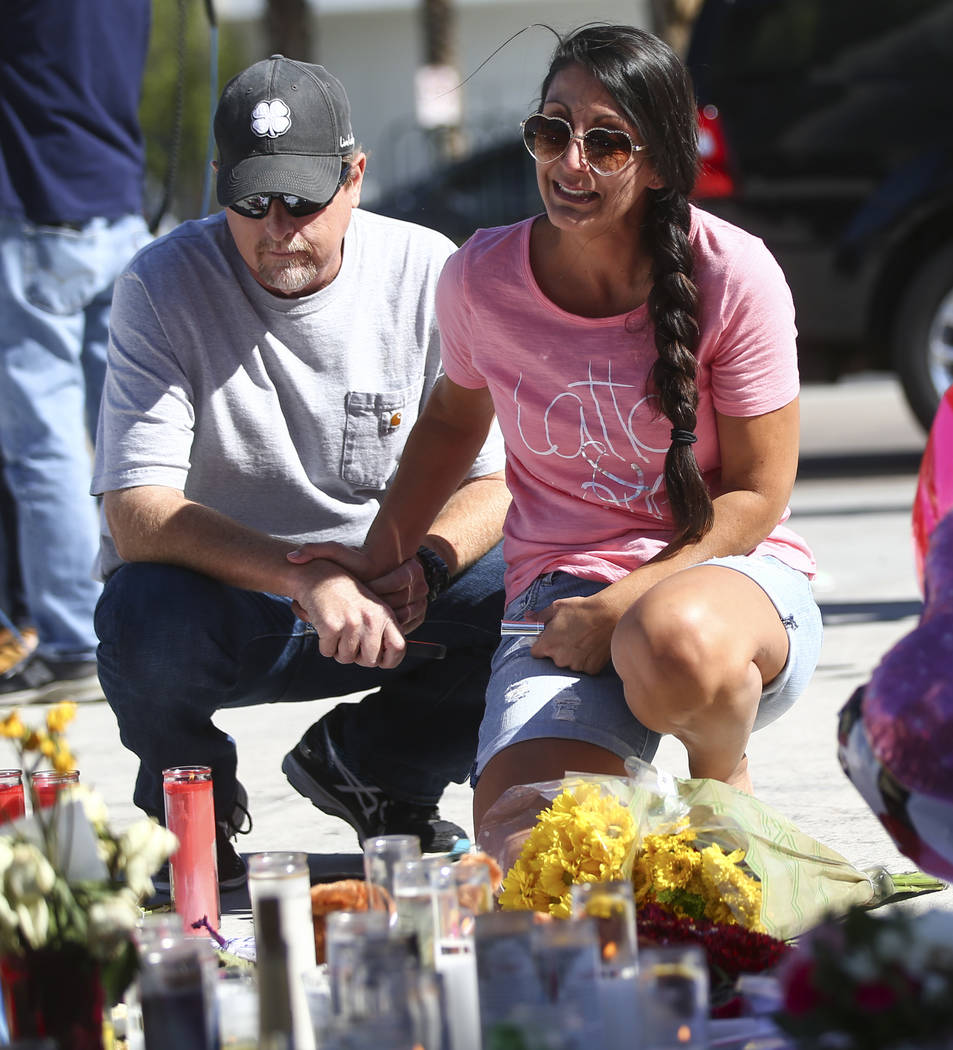 Mike and Jessica Yerkey of Ramona, Calif., pause at a memorial at Las Vegas Boulevard and Sahara Avenue in Las Vegas during the early hours of Tuesday, Oct. 3, 2017. Chase Stevens Las Vegas Review ...