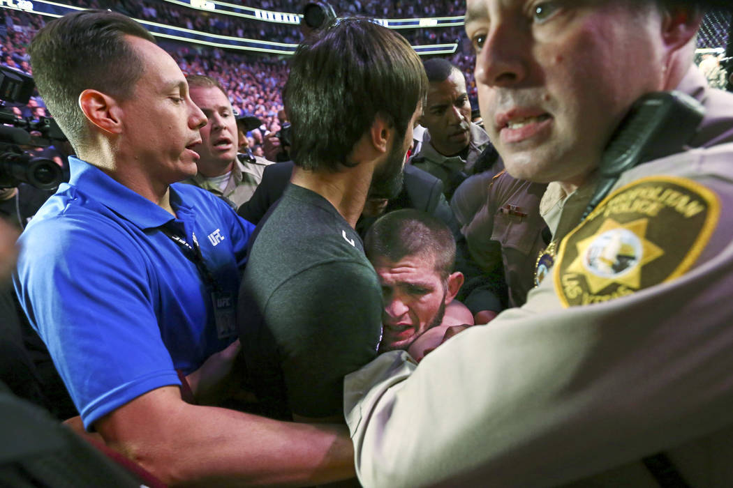 Khabib Nurmagomedov is restrained outside of the octagon after he defeated Conor McGregor at UFC 229 at T-Mobile Arena in Las Vegas on Saturday, Oct. 6, 2018. Chase Stevens Las Vegas Review-Journa ...