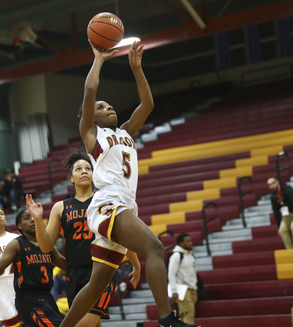 Del Sol's Markay Merchant (5) goes to the basket past Mojave's Chania Scott (25) during the first half of a basketball game at Del Sol High School in Las Vegas on Wednesday, Jan. 30, 2019. (Chase ...