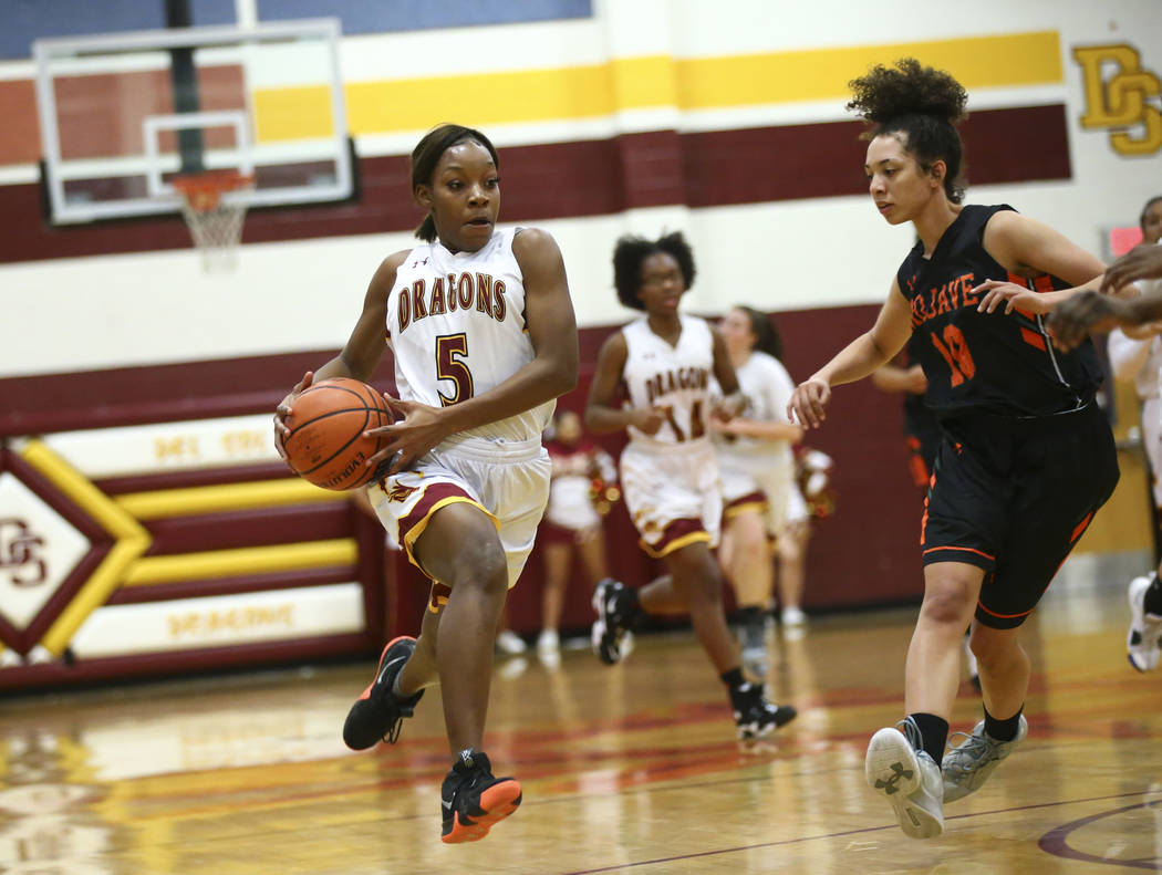 Del Sol's Markay Merchant (5) drives to the basket past Mojave's Ta'nyia Zeno (10) during the first half of a basketball game at Del Sol High School in Las Vegas on Wednesday, Jan. 30, 2019. (Chas ...