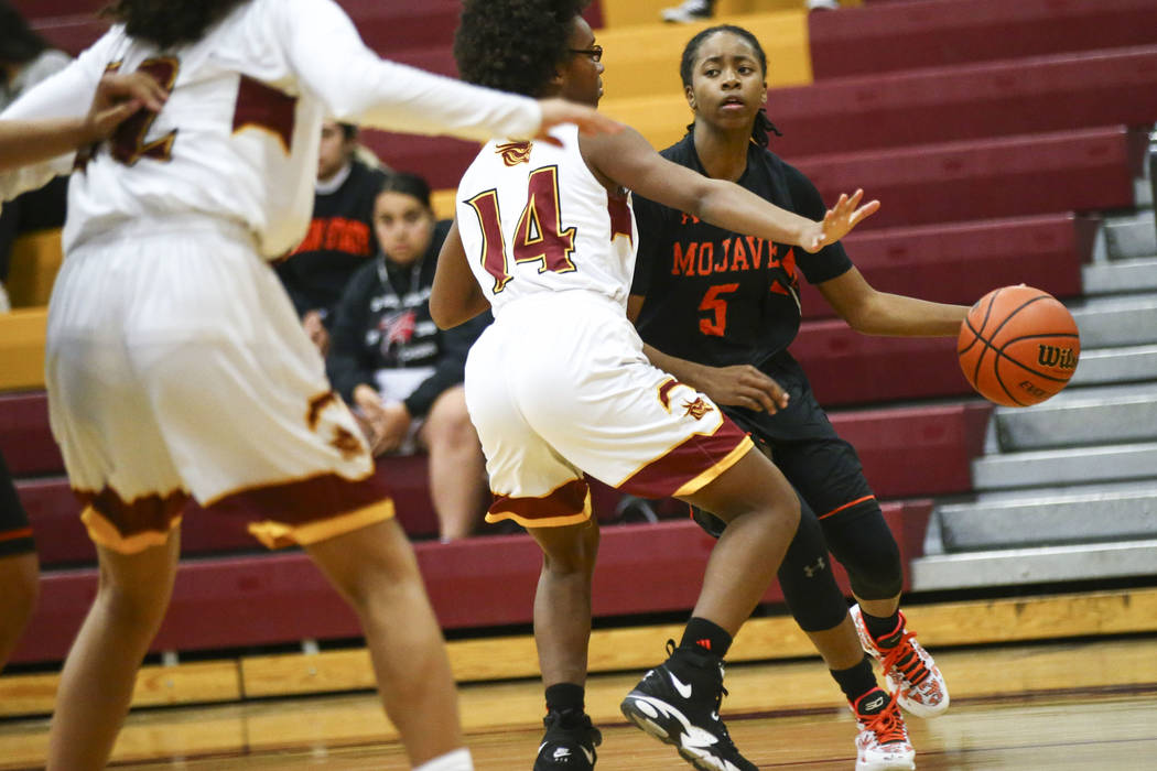 Mojave's Alecia Kelly (5) moves the ball around Del Sol's Nakala Nadeau (14) during the second half of a basketball game at Del Sol High School in Las Vegas on Wednesday, Jan. 30, 2019. (Chase Ste ...
