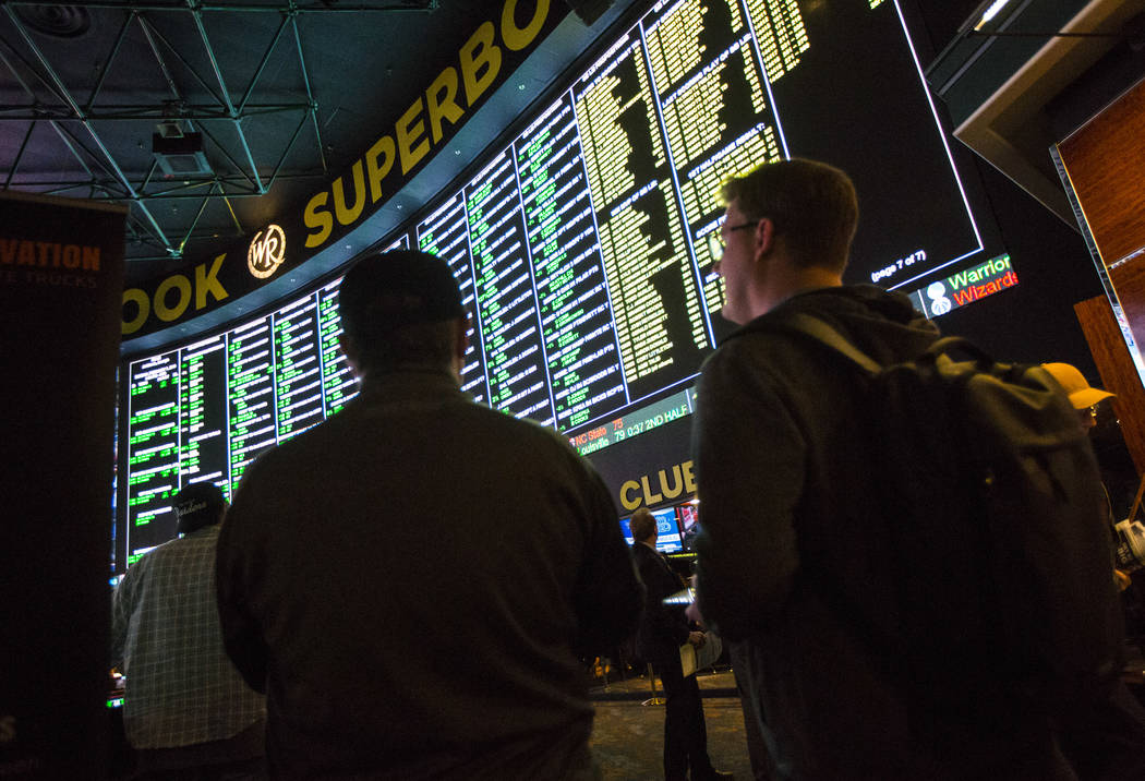 Bettors look at the display of prop bets for the Super Bowl at the Westgate Superbook in Las Vegas on Thursday, Jan. 24, 2019. The sportsbook posted 442 two-way props and more than 1,000 betting o ...