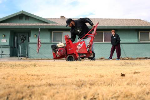 Mary Kiosowski Lewis, right, watches as Pacas Rivera of North West Landscape uses sod removal to remove old lawn from her front yard on Monday, Dec. 10, 2018. Bizuayehu Tesfaye Las Vegas Review-Jo ...