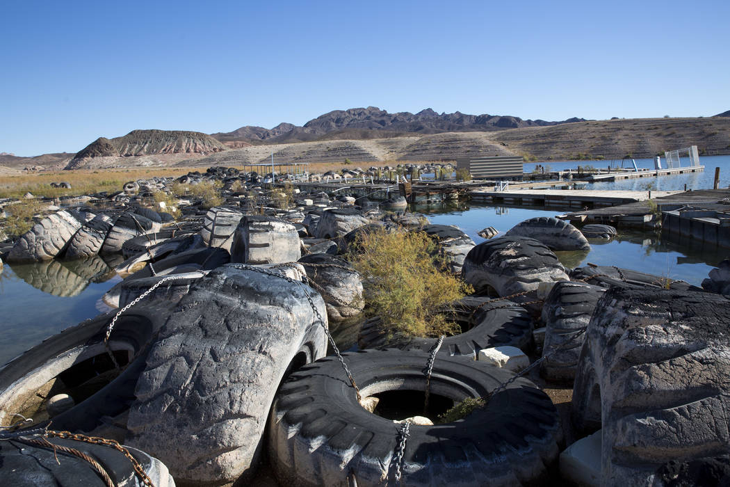 Rows of tires once used to control the wake and several defunct boating docks are seen pushed up against a shoreline just north of the Callville Bay Resort & Marina at Lake Mead National Recre ...