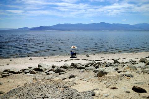 A man fishes for tilapia along the receding banks of the Salton Sea near Bombay Beach, Calif., April 30, 2015. (Gregory Bull/AP, File)