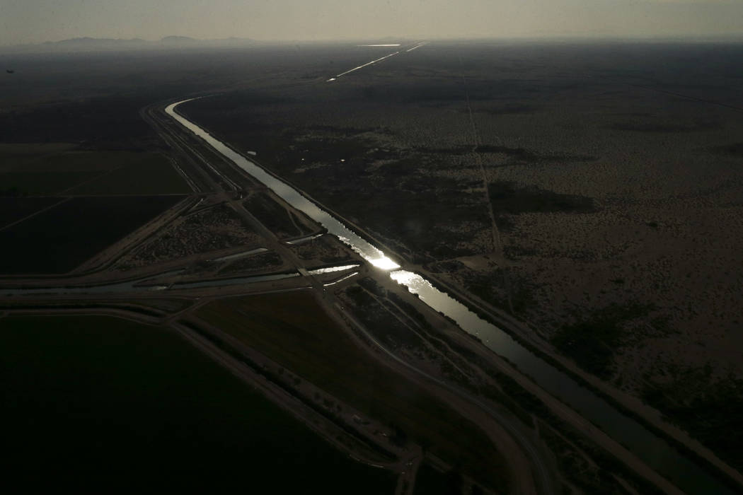 In this May 1, 2015, aerial photo, morning light reflects off water in the All-American Canal near Calexico, Calif. Colorado River water is diverted near Yuma, Arizona, to an 82-mile canal that ...