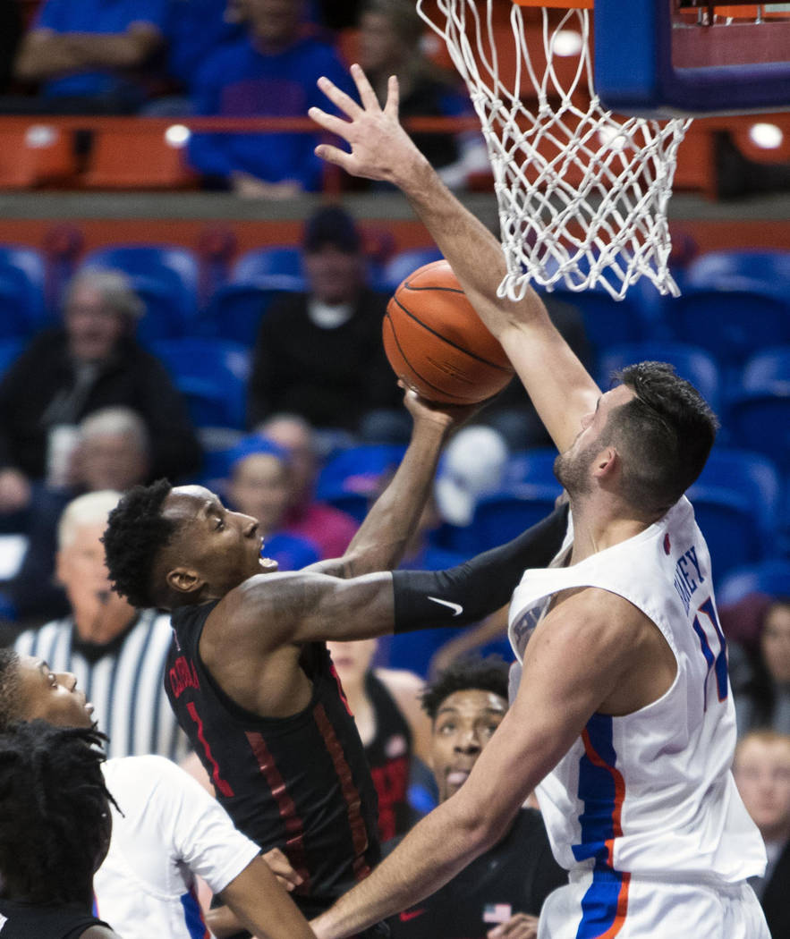 Boise State forward Zach Haney blocks a shot by UNLV guard Kris Clyburn during the first half of an NCAA college basketball game Wednesday, Feb. 6, 2019, in Boise, Idaho. (Darin Oswald/Idaho State ...