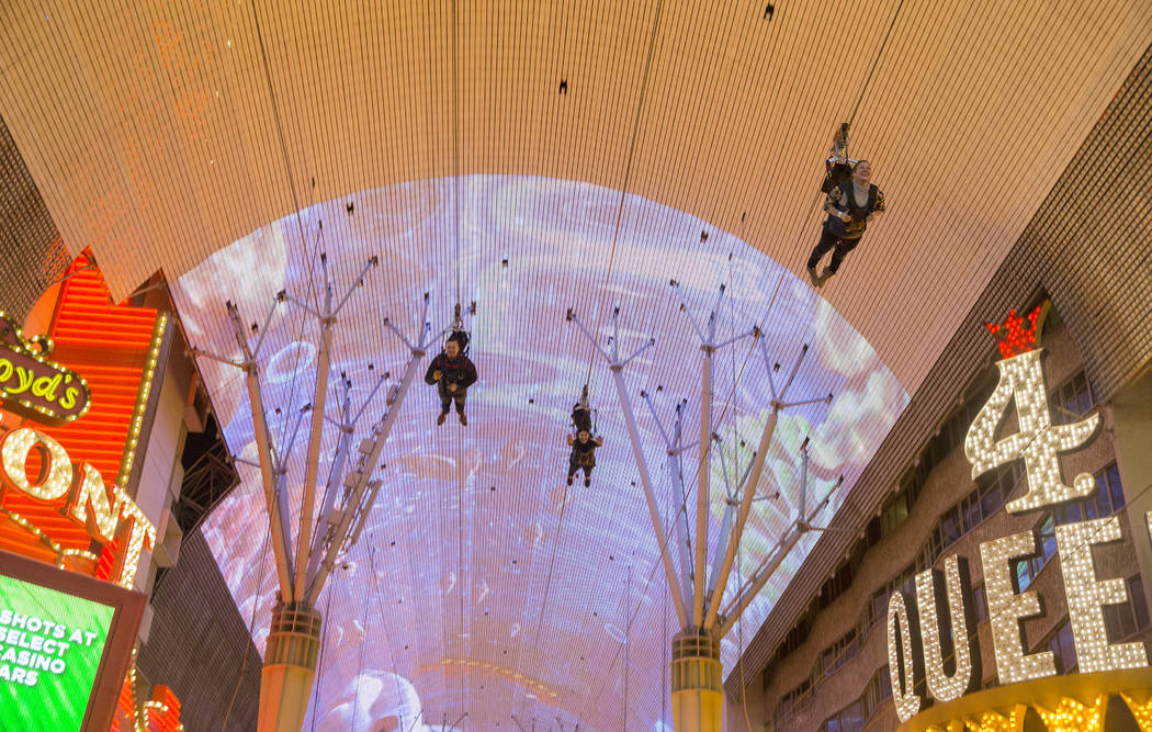 Zip liners pass above the Fremont Street Experience on Wednesday, Jan. 30, 2019, in Las Vegas. (Benjamin Hager/Las Vegas Review-Journal) @BenjaminHphoto