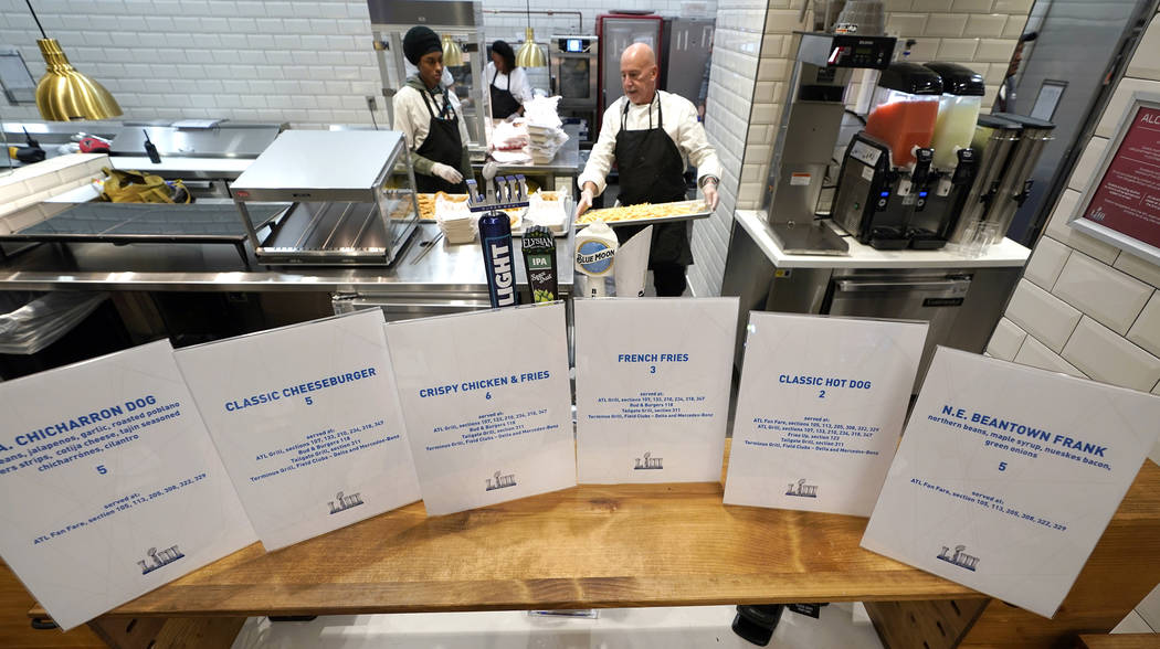 Food is prepared for a media tasting event during a tour of Mercedes-Benz Stadium for the NFL Super Bowl 53 football game Tuesday, Jan. 29, 2019, in Atlanta. (AP Photo/David J. Phillip)