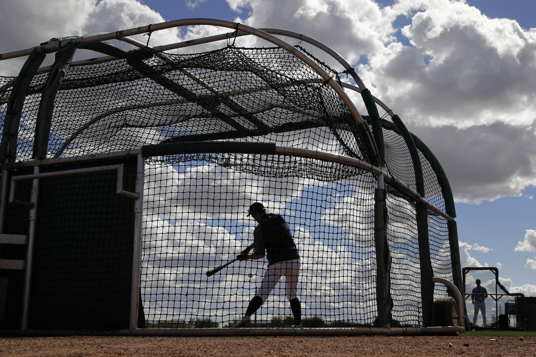 Seattle Mariners' Ichiro Suzuki bats during baseball spring training Saturday, Feb. 16, 2019, in Peoria, Ariz. (AP Photo/Charlie Riedel)