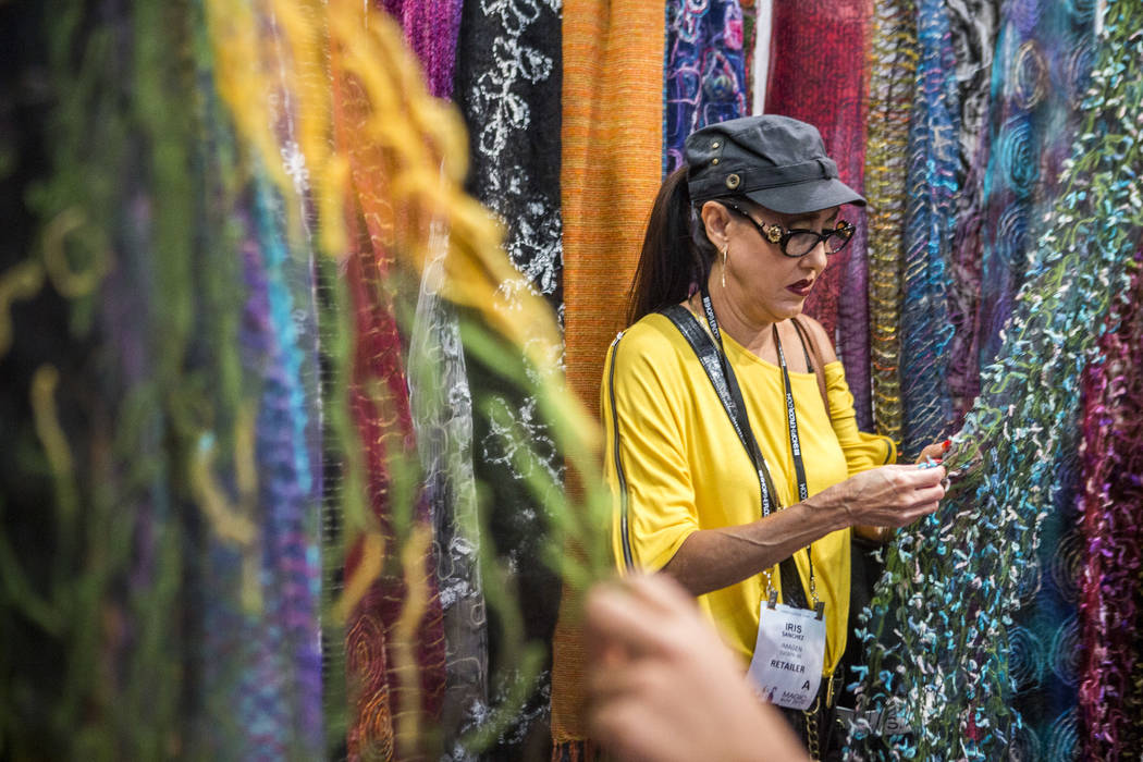 Iris Sanchez of Tucson, Arizona, browses scarves by Elegant Additions at the MAGIC trade show inside the Las Vegas Convention Center on Tuesday, Aug. 15, 2017. (Patrick Connolly/Las Vegas Review- ...