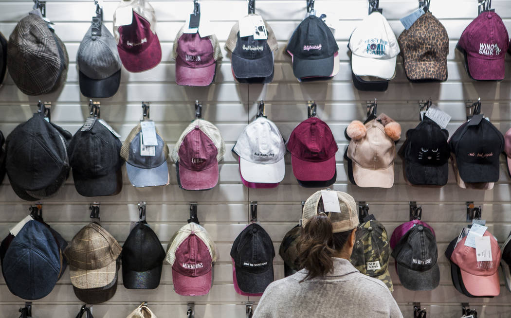 Gina Shin organizes hats by the David & Young Group at the MAGIC trade show inside the Las Vegas Convention Center on Tuesday, Aug. 15, 2017. Patrick Connolly Las Vegas Review-Journal @PConnPie