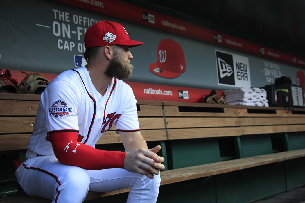 Washington Nationals Bryce Harper, looks at the baseball field from their dug out before the start of the Nationals last home game of the season against the Miami Marlins in Washington, Wednesday, ...