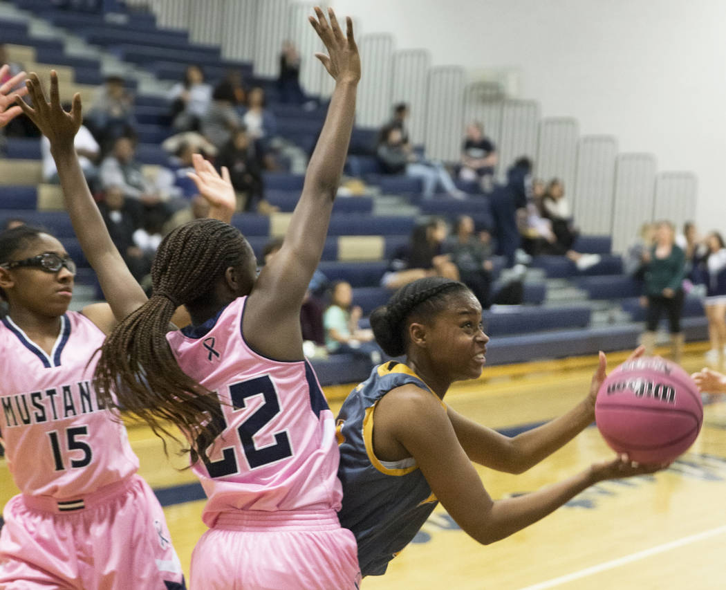 Bonanza senior Rayanna LeFear (21) slices to the rim past Shadow Ridge senior Vashay Young (22) in the second quarter on Monday, Feb. 4, 2019, at Shadow Ridge High School, in Las Vegas. (Benjamin ...