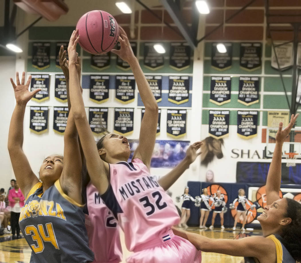 Shadow Ridge junior Christina Thames (32) fights for a rebound with Bonanza sophomore Saphire Mathews (34) in the first quarter on Monday, Feb. 4, 2019, at Shadow Ridge High School, in Las Vegas. ...