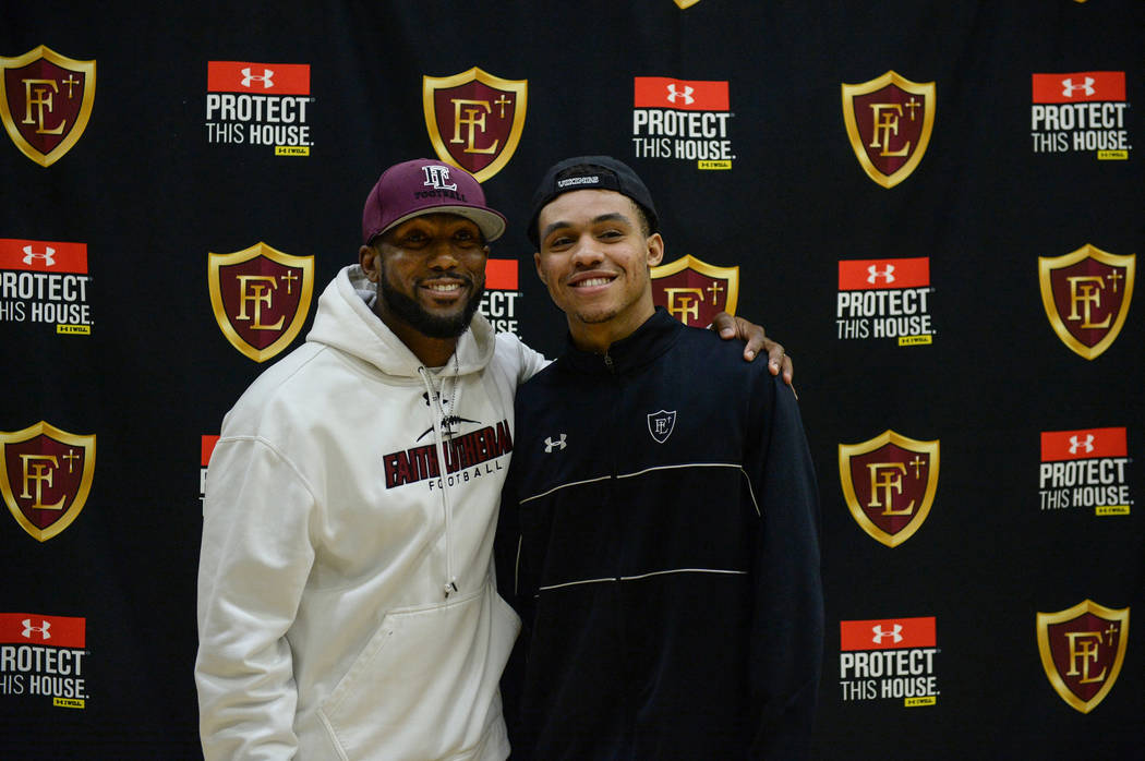 Faith Lutheran football coach Vernon Fox, left, poses with Faith Lutheran High School senior Greg Oliver after signing his national letter of intent to Portland State University in Las Vegas, Wedn ...