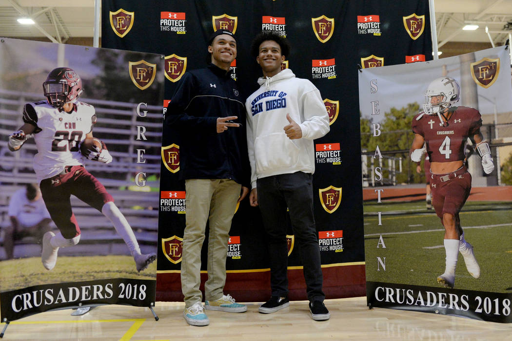 Faith Lutheran High School seniors Greg Oliver, left, and Sebastian Burke pose after signing their national letters of intent at Faith Lutheran High School in Las Vegas, Wednesday, Feb. 6, 2019. C ...