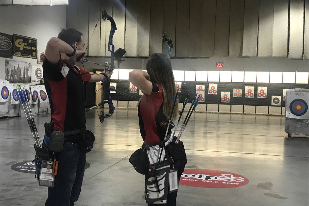 Haley West and Ryan Boring shoot arrows at Impact Archery on Friday, Feb. 1. (Rachel Spacek/Las Vegas Review-Journal @RachelSpacek)