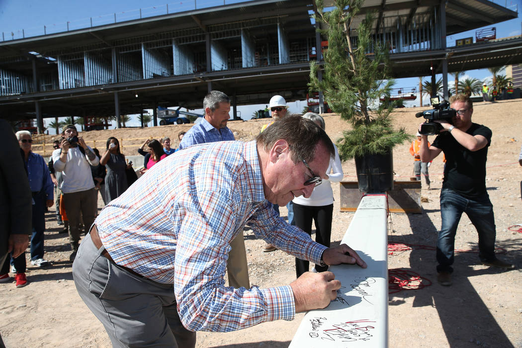 Retired Las Vegas Convention and Visitors Authority CEO Rossi Ralenkotter signs a steel beam during a topping off ceremony at the Las Vegas Ballpark construction site in Las Vegas, Thursday, Oct. ...