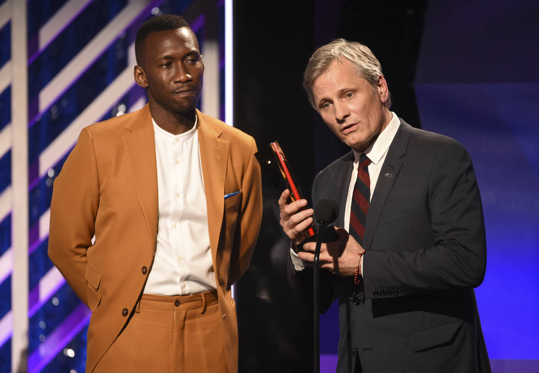 CORRECTS MONTH TO FEBRUARY INSTEAD OF JANUARY - Mahershala Ali, left, presents the Best Actor award to Viggo Mortensen for "Green Book" during the 18th Annual Movies For Grownups Awards ...