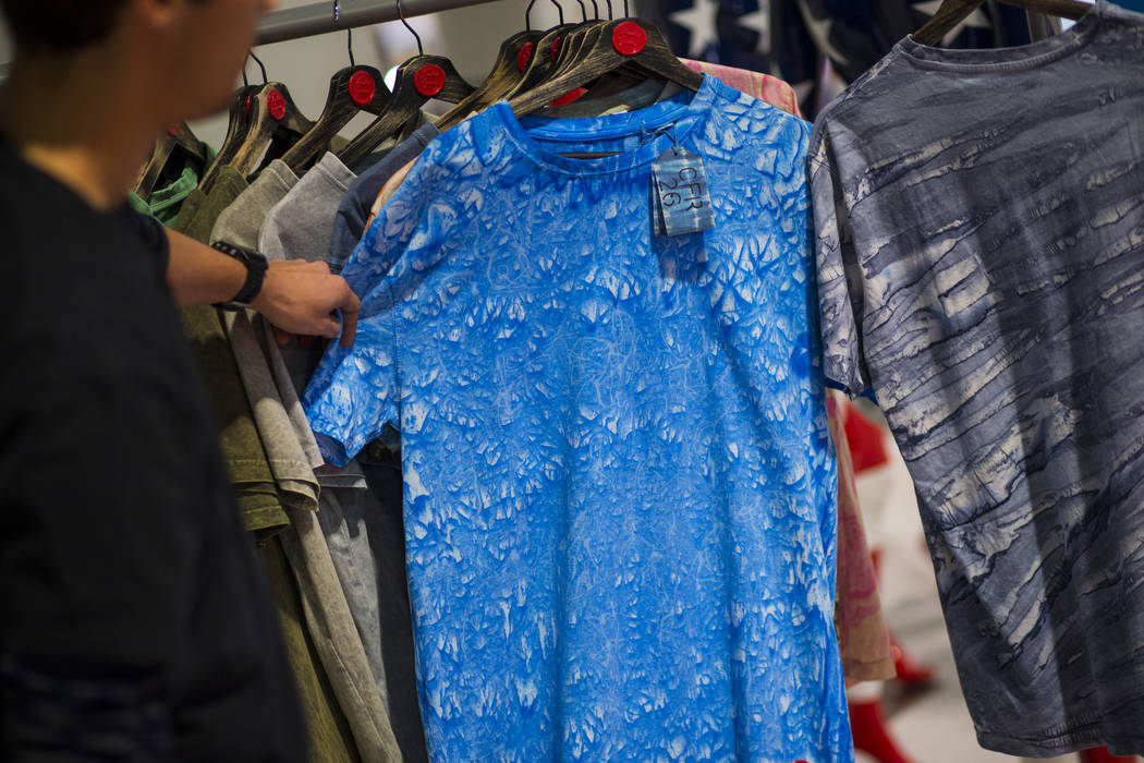 Josep Segura of Tintes Egara shows shirts dyed with eco-friendly materials during the Sourcing at MAGIC trade show at the Las Vegas Convention Center in Las Vegas on Wednesday, Feb. 6, 2019. (Chas ...