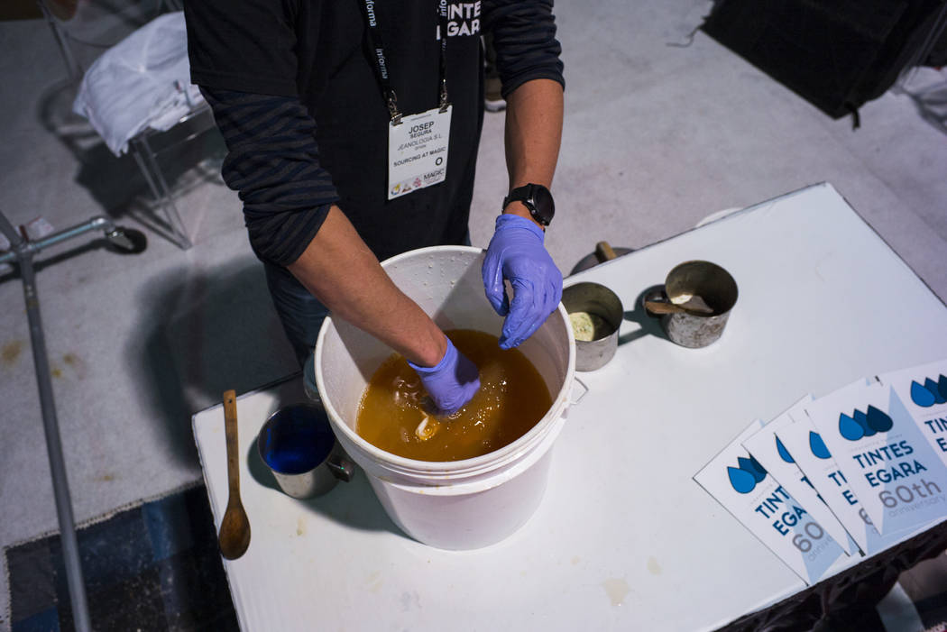 Josep Segura of Tintes Egara hand-dyes a shirt using eco-friendly materials during the Sourcing at MAGIC trade show at the Las Vegas Convention Center in Las Vegas on Wednesday, Feb. 6, 2019. (Cha ...