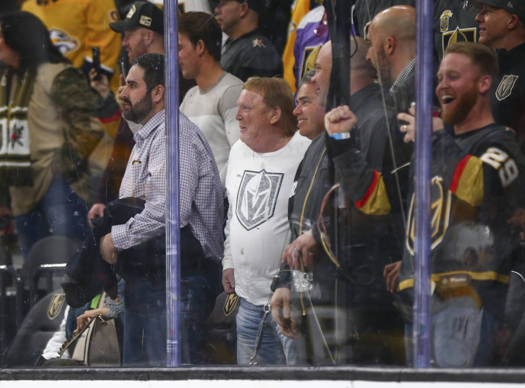Oakland Raiders owner Mark Davis, center in white, attends an NHL hockey game between the Golden Knights and Nashville Predators at T-Mobile Arena in Las Vegas on Wednesday, Jan. 23, 2019. (Chase ...