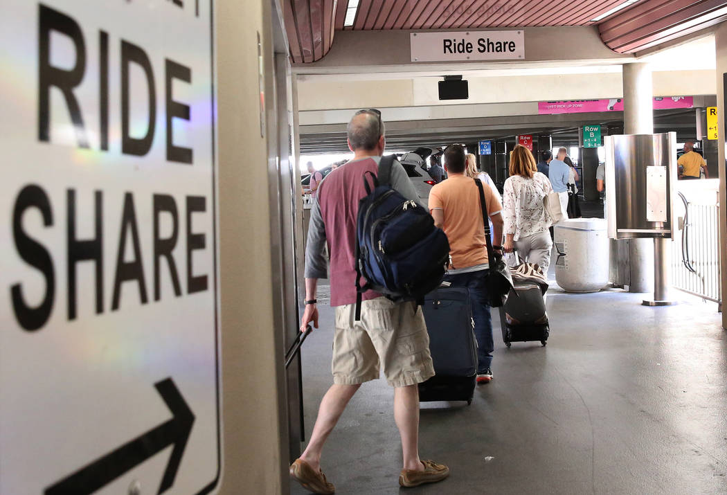 Riders arrive at Ride-hailing companies' Uber and Lyft pick up area at McCarran International Airport at Terminal 1 on Thursday, June 1, 2017, in Las Vegas. Bizuayehu Tesfaye Las Vegas Review-Jour ...